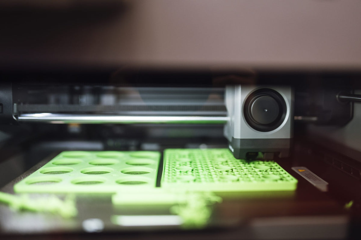 Print head over a plate of printed parts