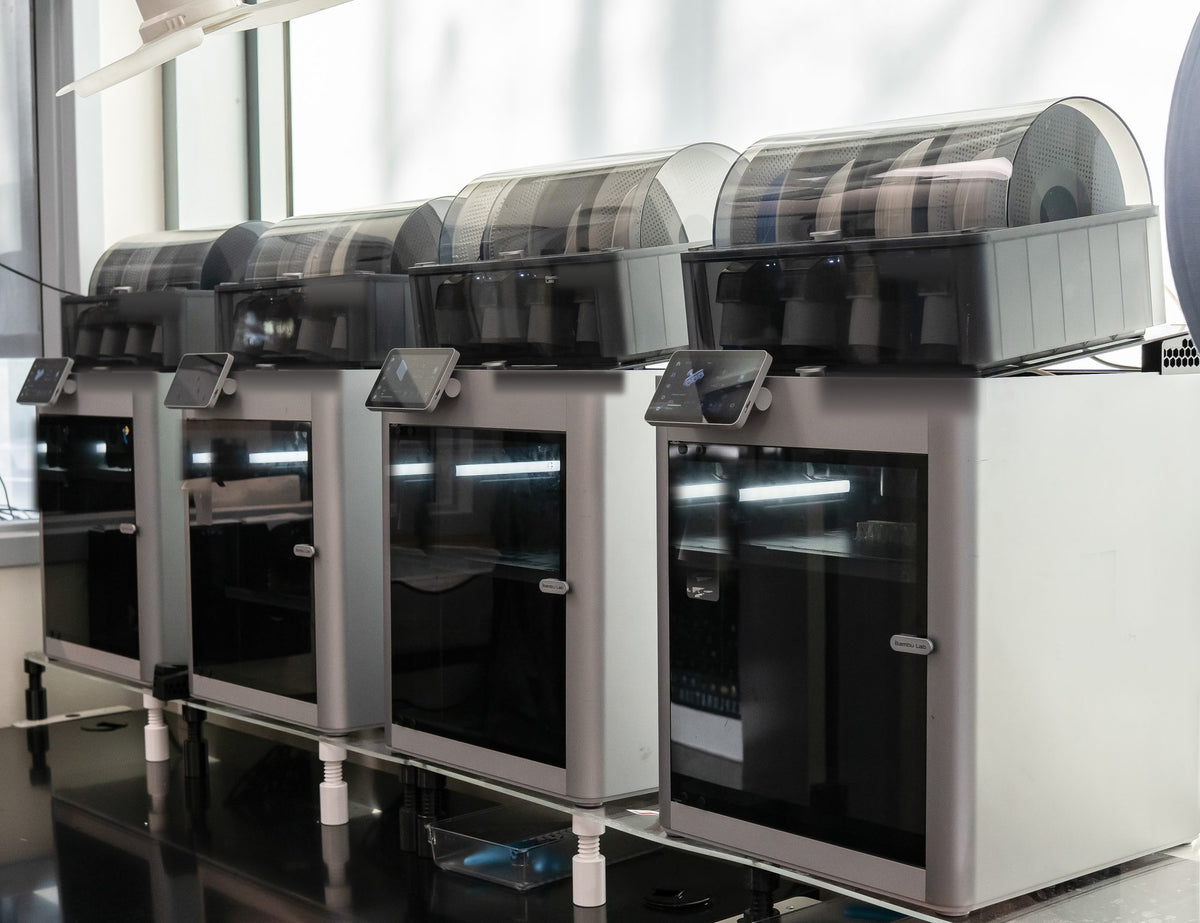 Enclosed 3D printers in a row